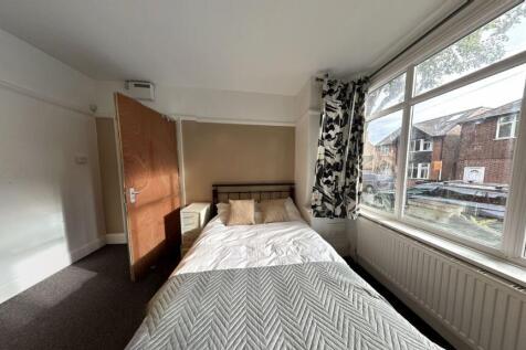 Bright and inviting bedroom with a large window...