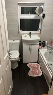 Sleek contemporary bathroom with storage vanity...