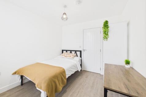 A bright and inviting single bedroom featuring ...
