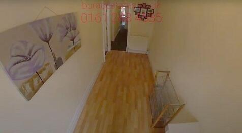 Bright inviting hallway with wood-style floorin...