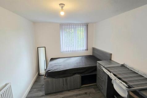 Neat single bedroom with a raised storage bed, ...