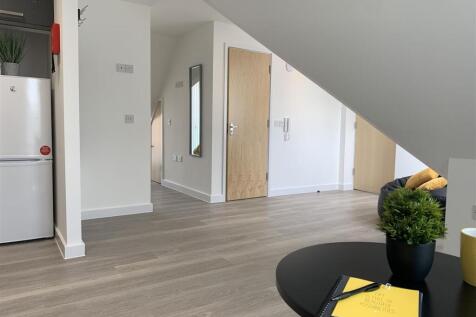 Modern bright hallway with sleek wood flooring...