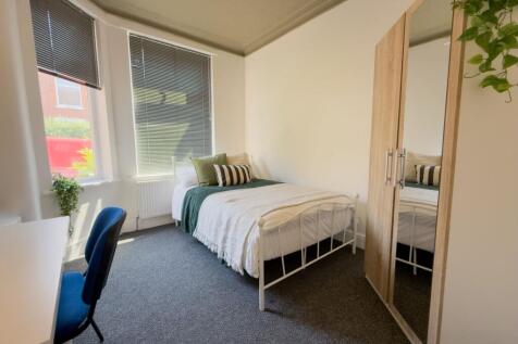 Bright bedroom with workspace and ample storage...
