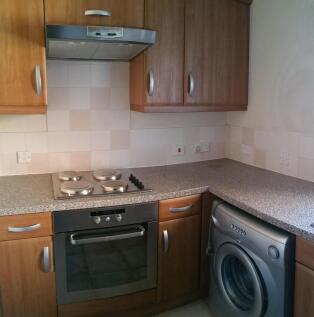 Compact fitted kitchen with integrated oven and...