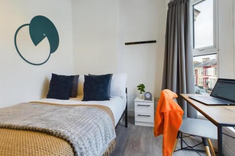 A bright and inviting double bedroom with moder...