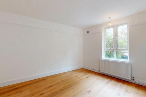 A bright, spacious living room with large windo...