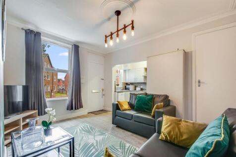 Bright, stylish living room with large window, ...