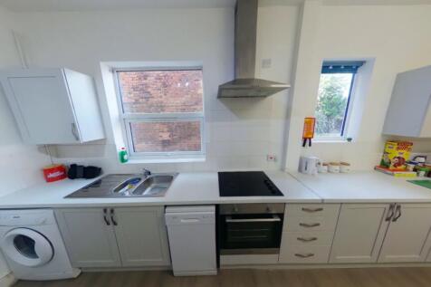 A bright and modern kitchenette equipped with e...