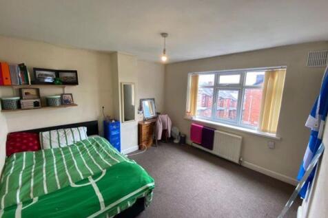 Bright and spacious master bedroom featuring a ...