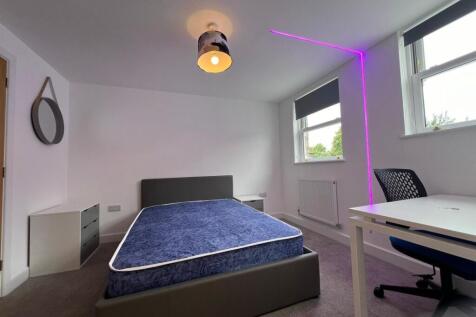 Bright, modern bedroom with a comfortable uphol...