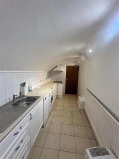 Unique vaulted galley kitchen with washing mach...