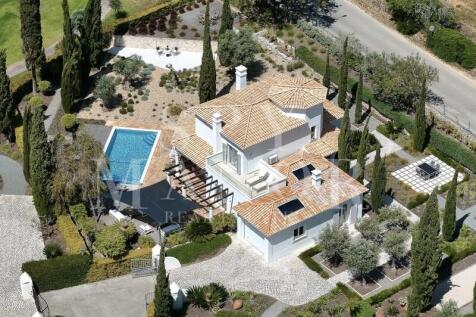 Aerial view of a frontline golf villa at Gramacho Golf Course, Algarve. Luxury property with private pool, Mediterranean garden, and large plot in Lagoa.
