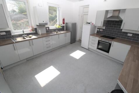 Spacious modern kitchen with sleek white units...
