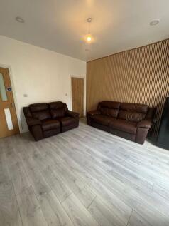 Bright, modern living room with light wood-effe...