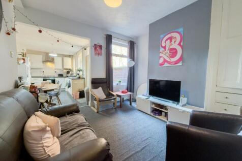 Bright, modern shared lounge with seating and T...