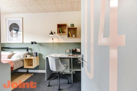 Stylish modern bedroom with dedicated study are...