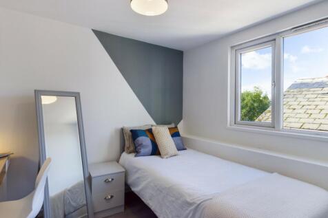 A bright and modern double bedroom with stylish...