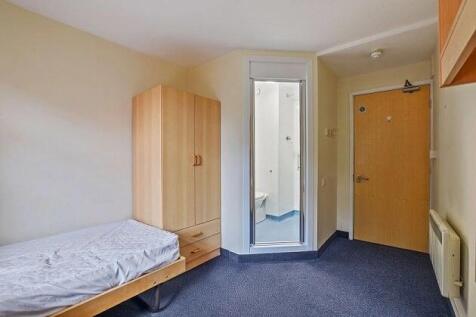 Tidy bedroom featuring private ensuite access...
