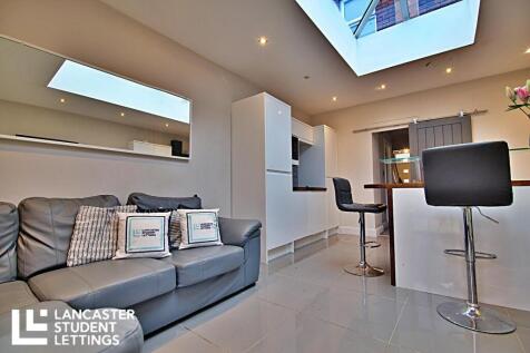 Bright modern living area with stylish skylight...