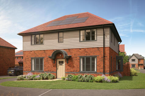A modern brick and siding house with solar panels on its roof sits on a manicured lawn
