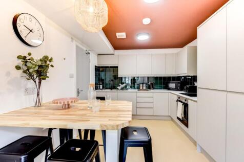 Bright modern kitchen with a wooden breakfast b...