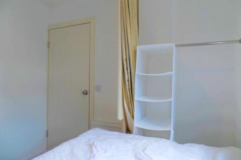 Bright and tidy single bedroom featuring a neat...