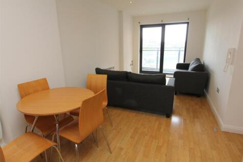 Bright lounge with a dining area and balcony....