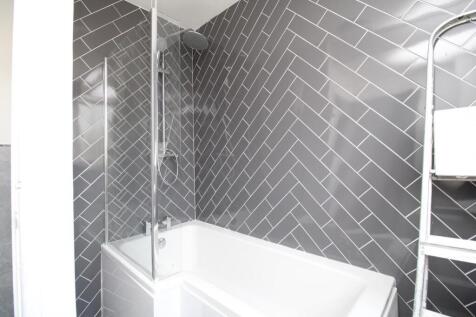 Modern bathroom with stylish herringbone tiling...