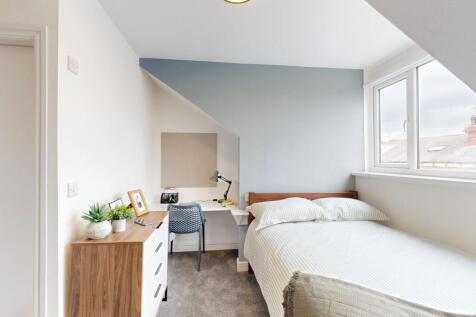 A bright and inviting bedroom with a comfortabl...