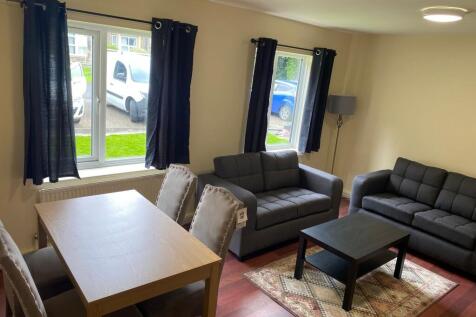 A bright and inviting living room featuring two...