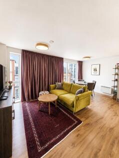 Elegant living area with stylish velvet sofa...