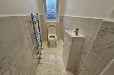 Elegant marble-effect tiling and heated rail...
