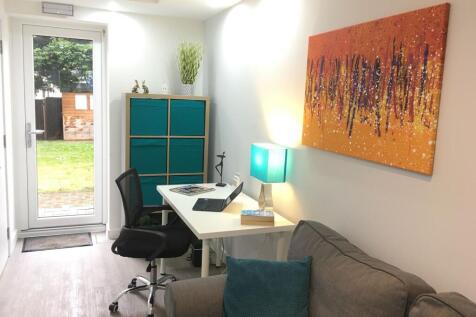 Bright, modern workspace with a white desk, erg...