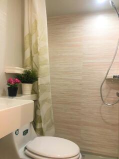 A clean and modern bathroom featuring a shower ...