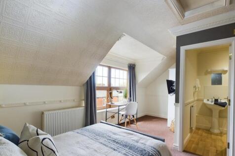 A cozy and bright double bedroom featuring a co...