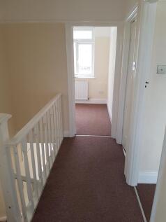 A spacious and well-maintained hallway with nat...