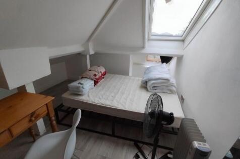 Bright attic bedroom with a skylight window....
