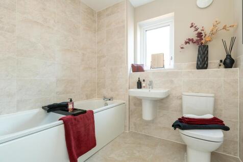 A modern family bathroom completes the home