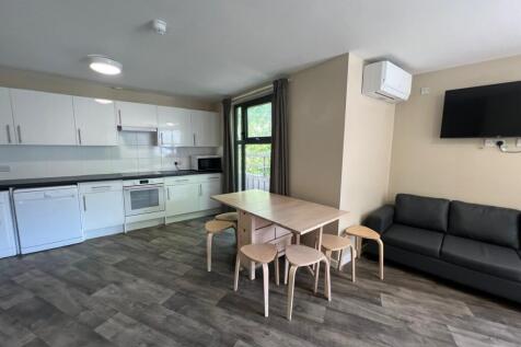 Bright open-plan kitchen and living area with m...