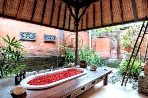 An outdoor spa area features a bathtub filled with