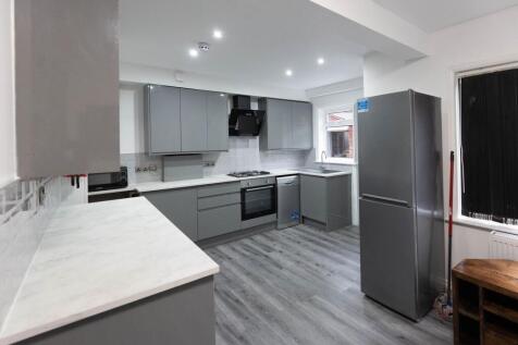 Modern and sleek kitchen with grey cabinetry, w...