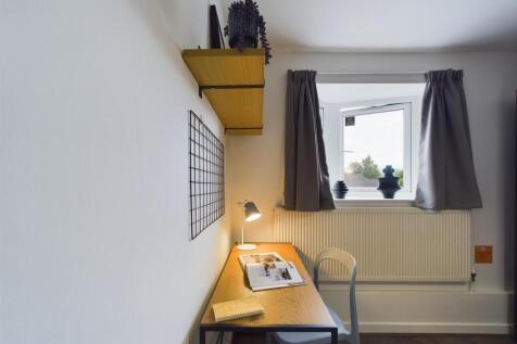 Compact, tidy single bedroom with a study desk,...