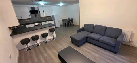 Modern open-plan living area with a grey L-shap...