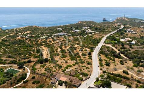 Aerial view of the Skyblade development plot in Ferragudo, Algarve, showcasing the real estate land with panoramic ocean views near Praia dos Caneiros beach.