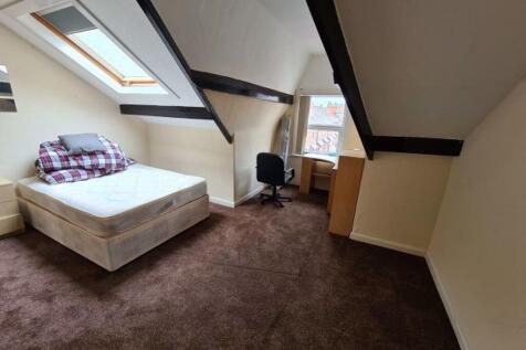 A cozy and well-maintained bedroom with a comfo...