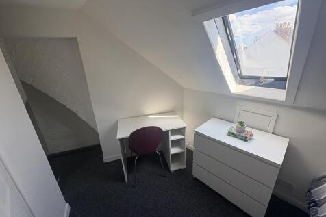 Bright attic single room with desk and storage...