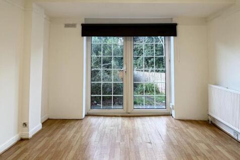 Bright, neutral living room with large glazed p...