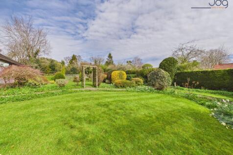 Wraparound mature gardens with expansive lawns