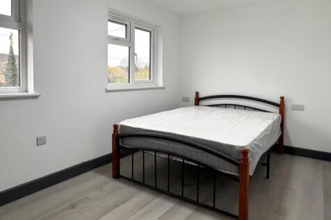 Bright, simply styled bedroom with a double bed...