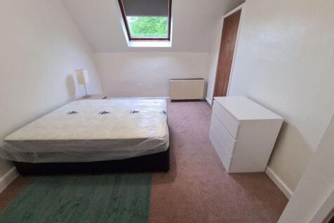 A neat single bedroom featuring a comfortable b...